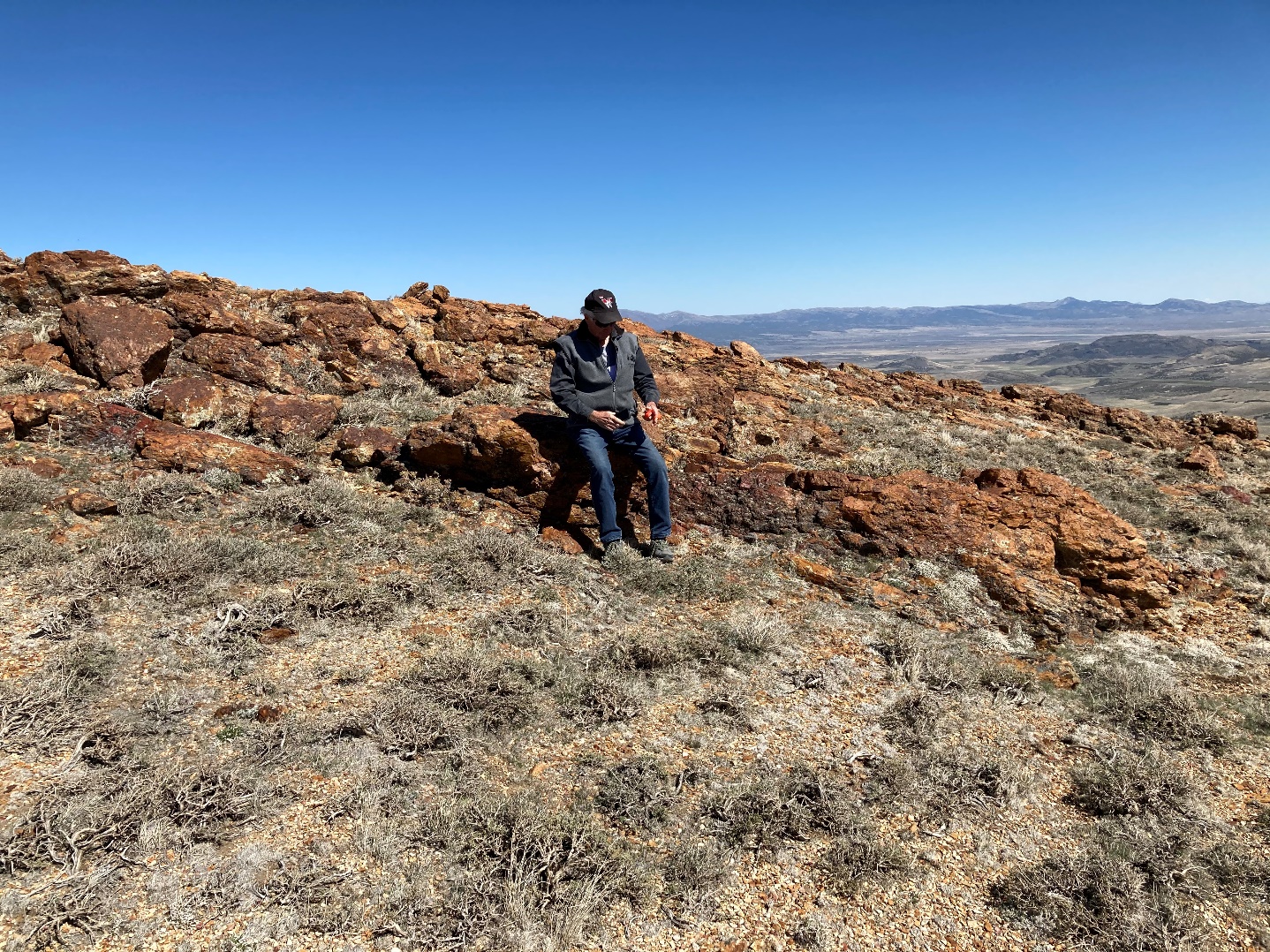 A person sitting on a hill

Description automatically generated with medium confidence